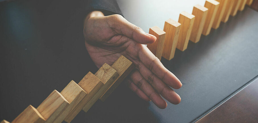 Problem solving close up view hand business woman stopping falling blocks table concept about taking responsibility