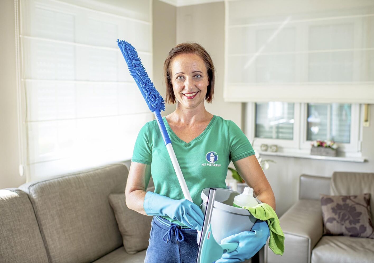 Liesbeth houd een emmer en een dweil in haar handen 2019